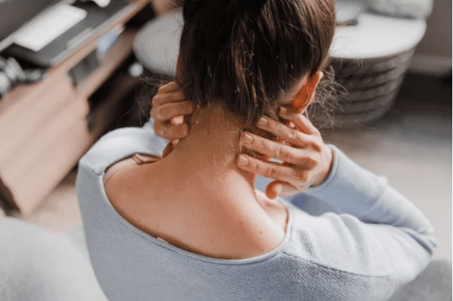 Female holding her neck in pain