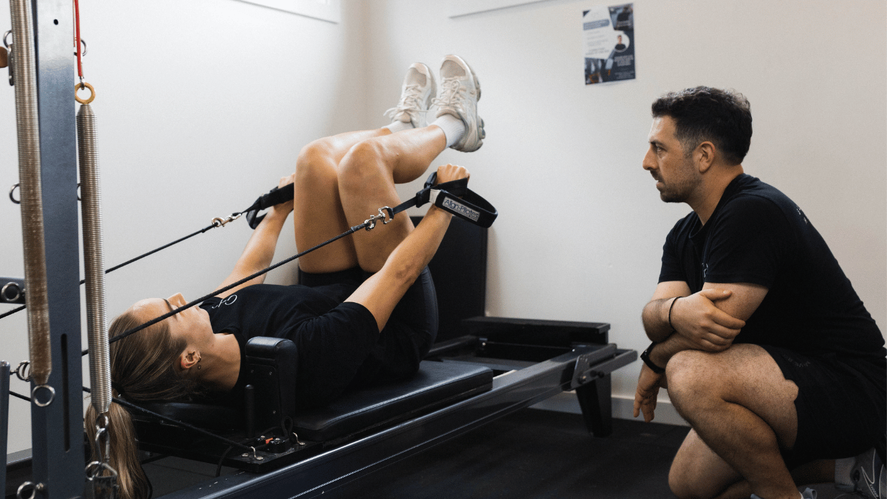 Marcus Drivas instructing Kezie Apps on the Reformer at Gladesville Healthcare